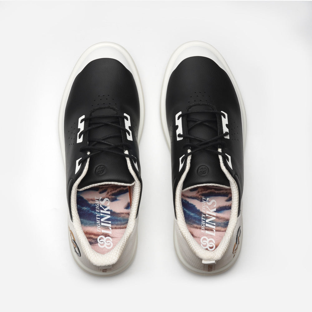 Black sneakers with a colorful sole on a white background sell at Paradise Golf