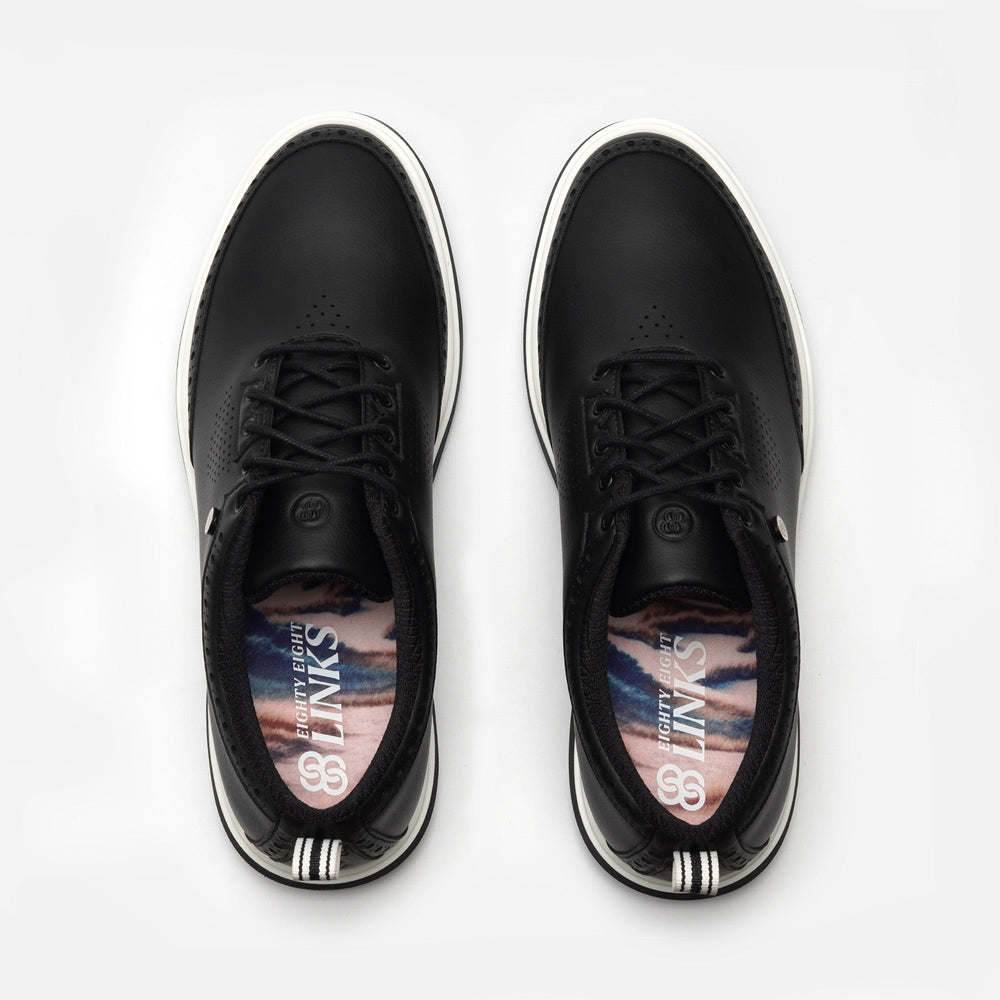 Black sneakers with a visible brand logo on a white background sells at Paradise Golf