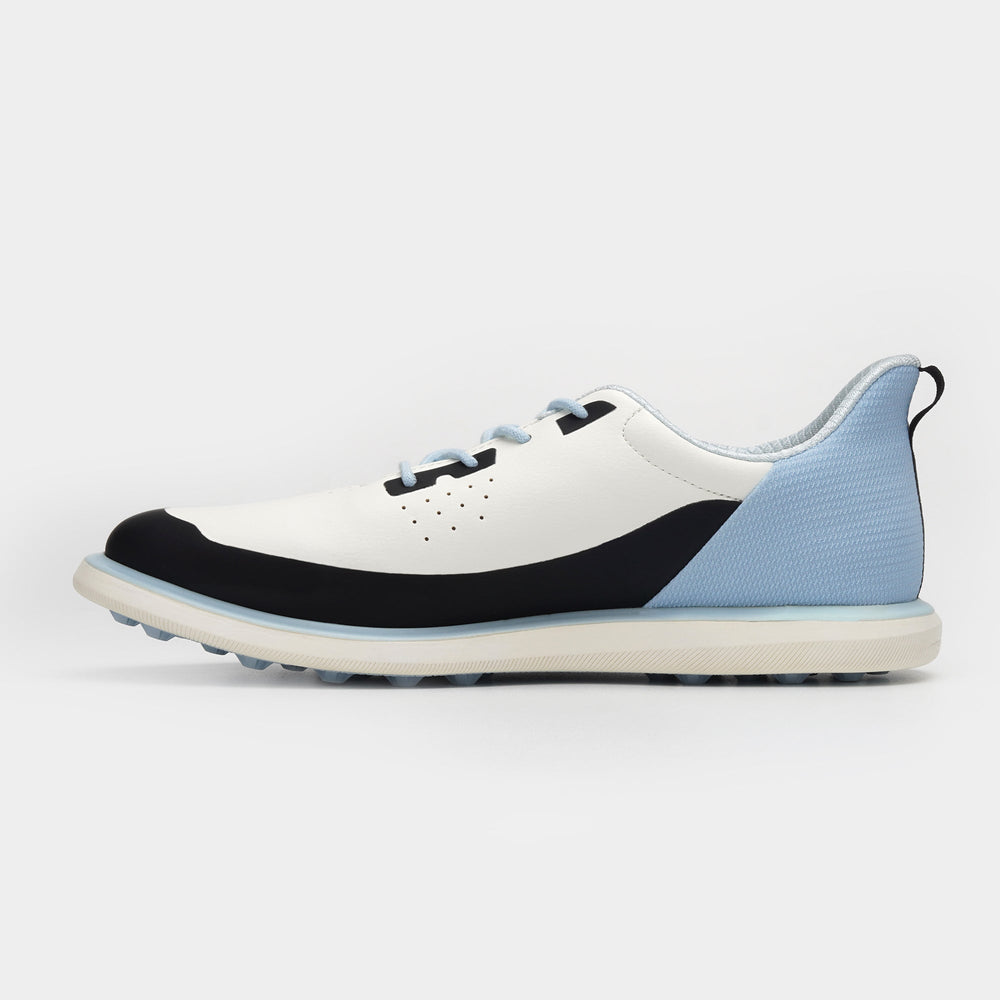White, black, and blue athletic shoe on a light gray background sells at Paradise Golf