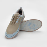 A pair of tan and blue shoes on a white background sells at Paradise Golf