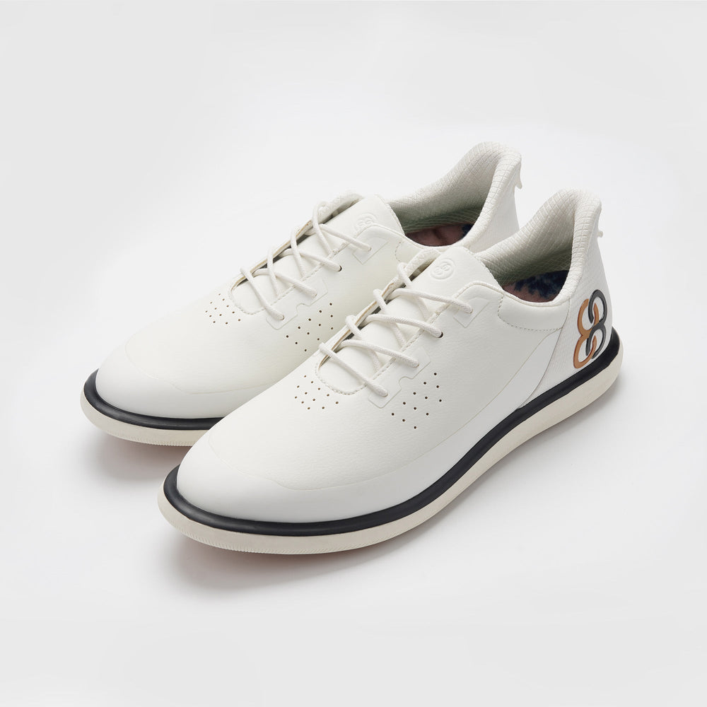 White sneakers with black accents on a light gray background sell at Paradise Golf