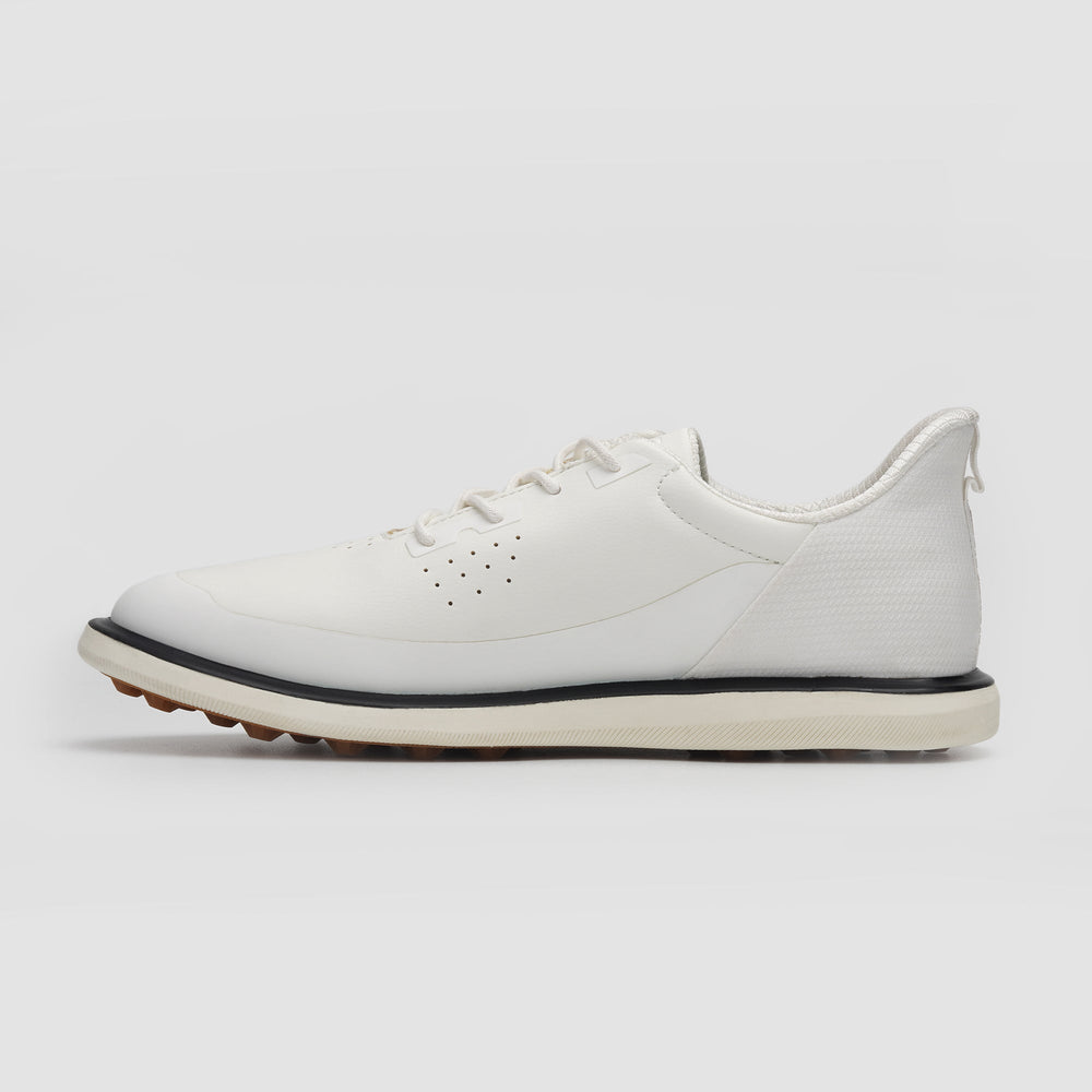 White sneaker with a black sole on a light gray background sells at Paradise Golf