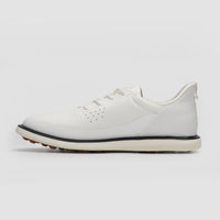 White sneaker with a black sole on a light gray background sells at Paradise Golf