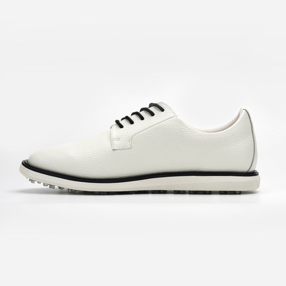 White sneaker with black accents on a white background sells at Paradise Golf