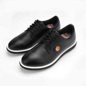 A pair of black leather shoes with a brand logo on a white background sells at Paradise Golf