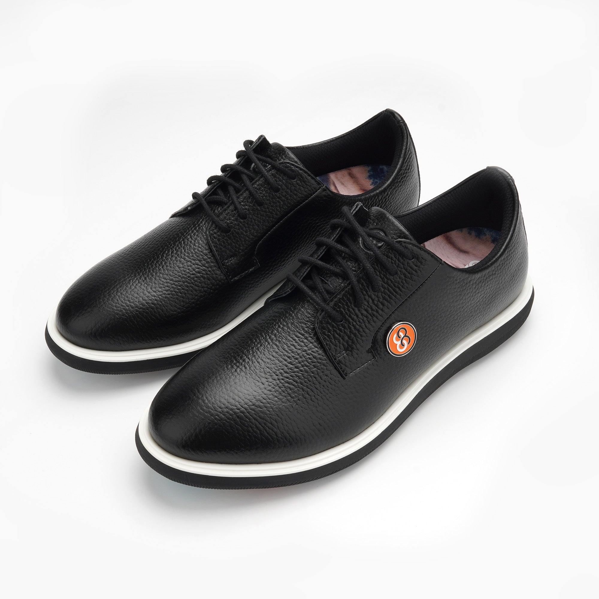 A pair of black leather shoes with a brand logo on a white background sells at Paradise Golf