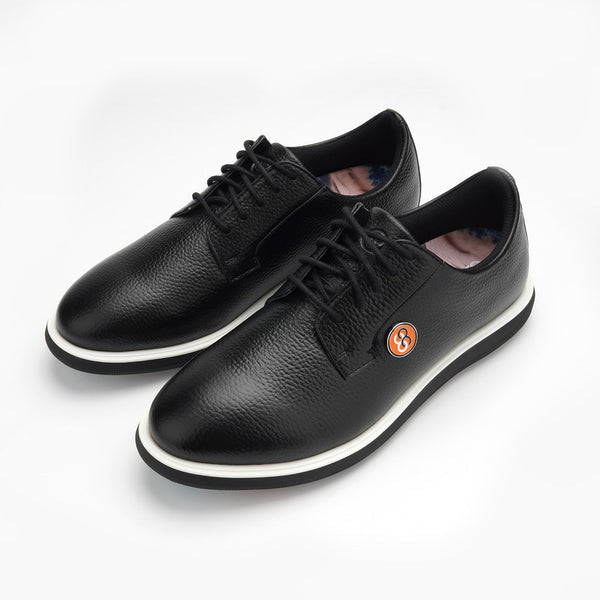 A pair of black leather shoes with a brand logo on a white background sells at Paradise Golf