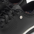 Close-up of black sneakers with a brand logo on a white background sells at Paradise Golf