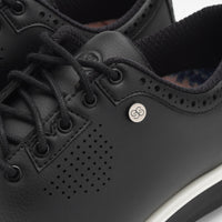 Close-up of black sneakers with a brand logo on a white background sells at Paradise Golf