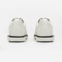 White sneakers with black soles on a white background sells at Paradise Golf