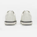 White sneakers with black soles on a white background sells at Paradise Golf