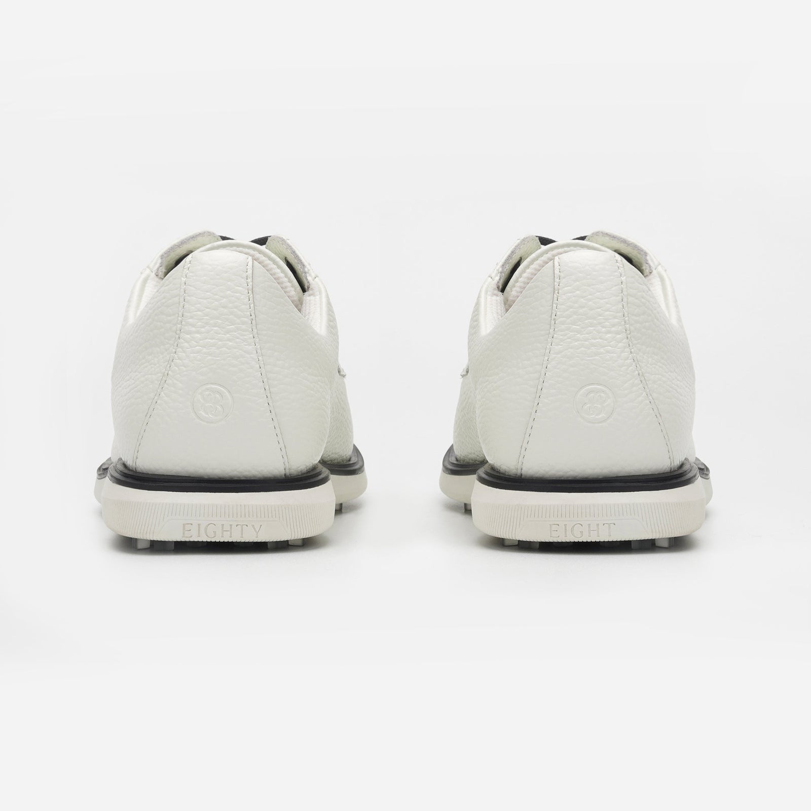 White sneakers with black soles on a white background sells at Paradise Golf