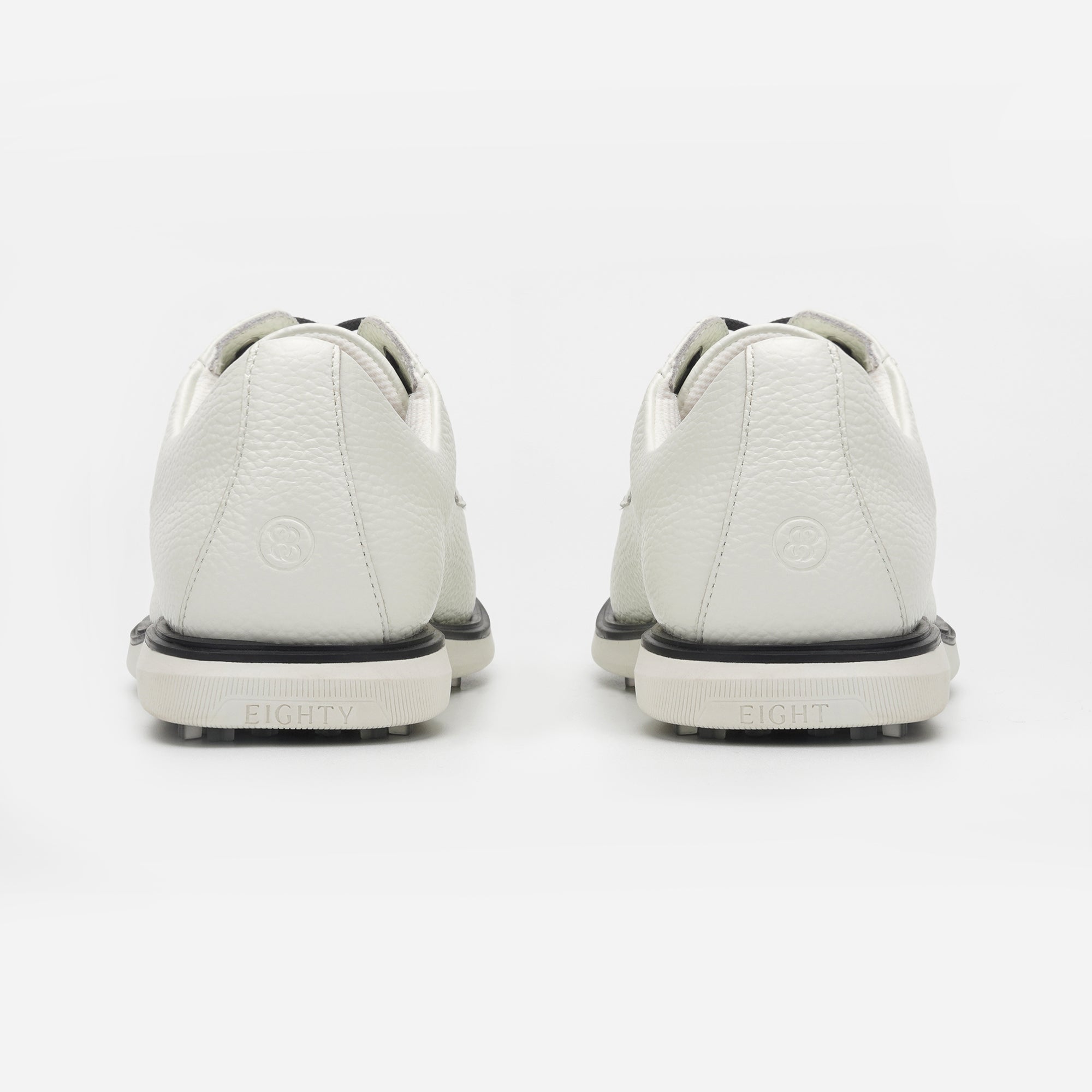 White sneakers with black soles on a white background sells at Paradise Golf