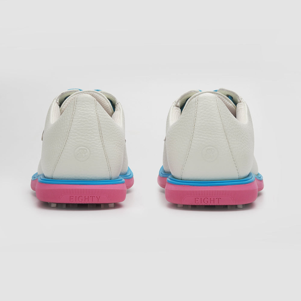 White sneakers with blue and pink soles on a white background sells at Paradise Golf