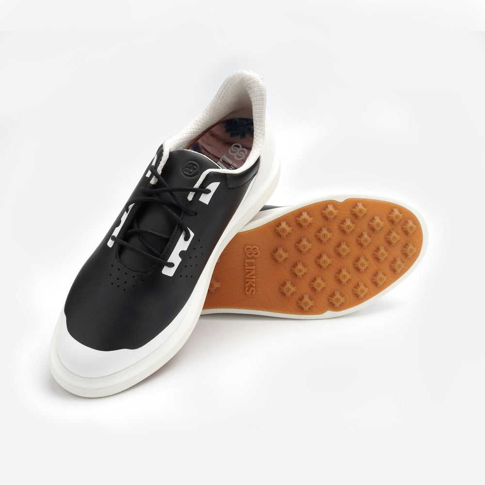 Black and white sneaker with brown sole on a white background sells at Paradise Golf