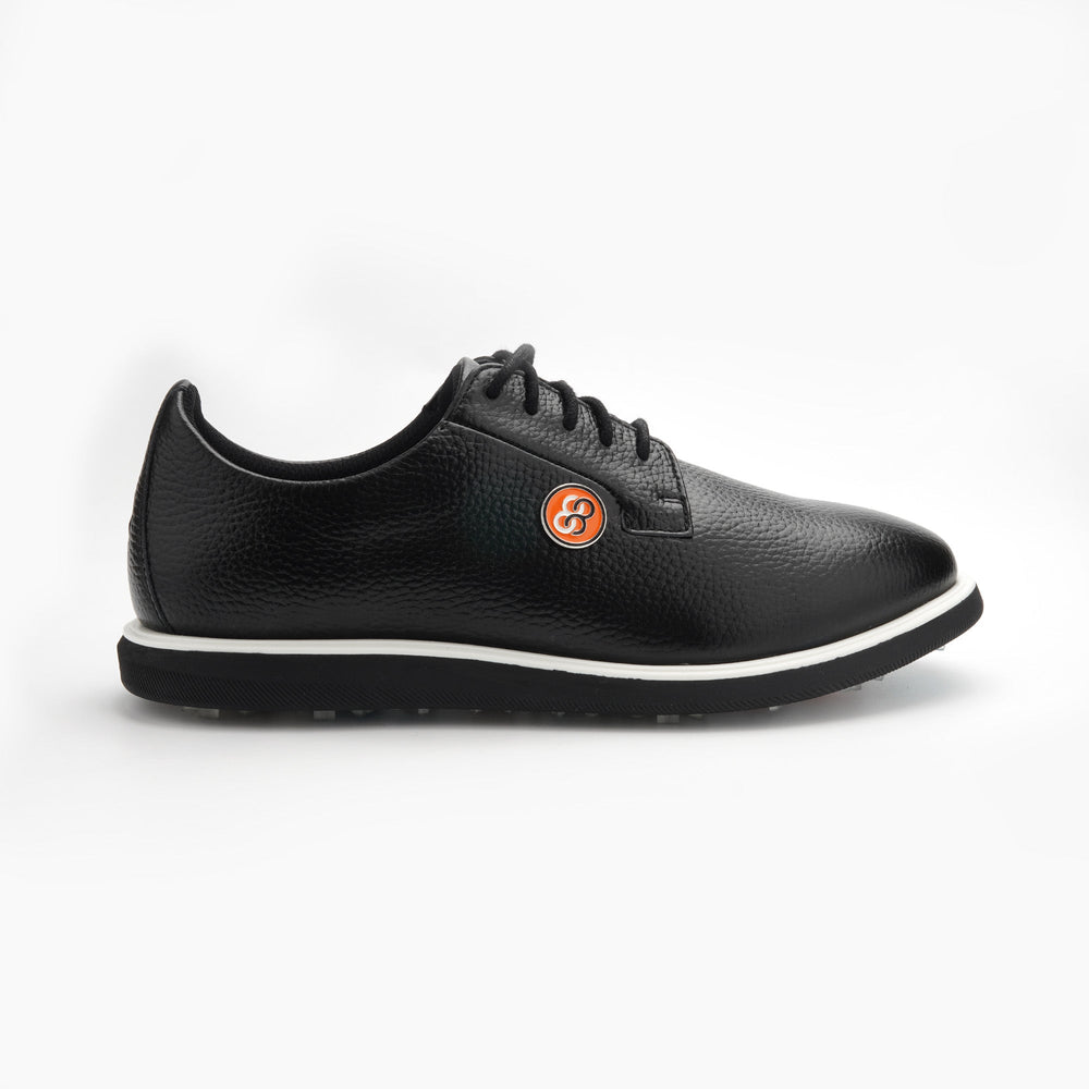 Black sneaker with a brand logo on a white background sells at Paradise Golf