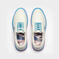 White sneakers with blue accents on a light gray background sells at Paradise Golf