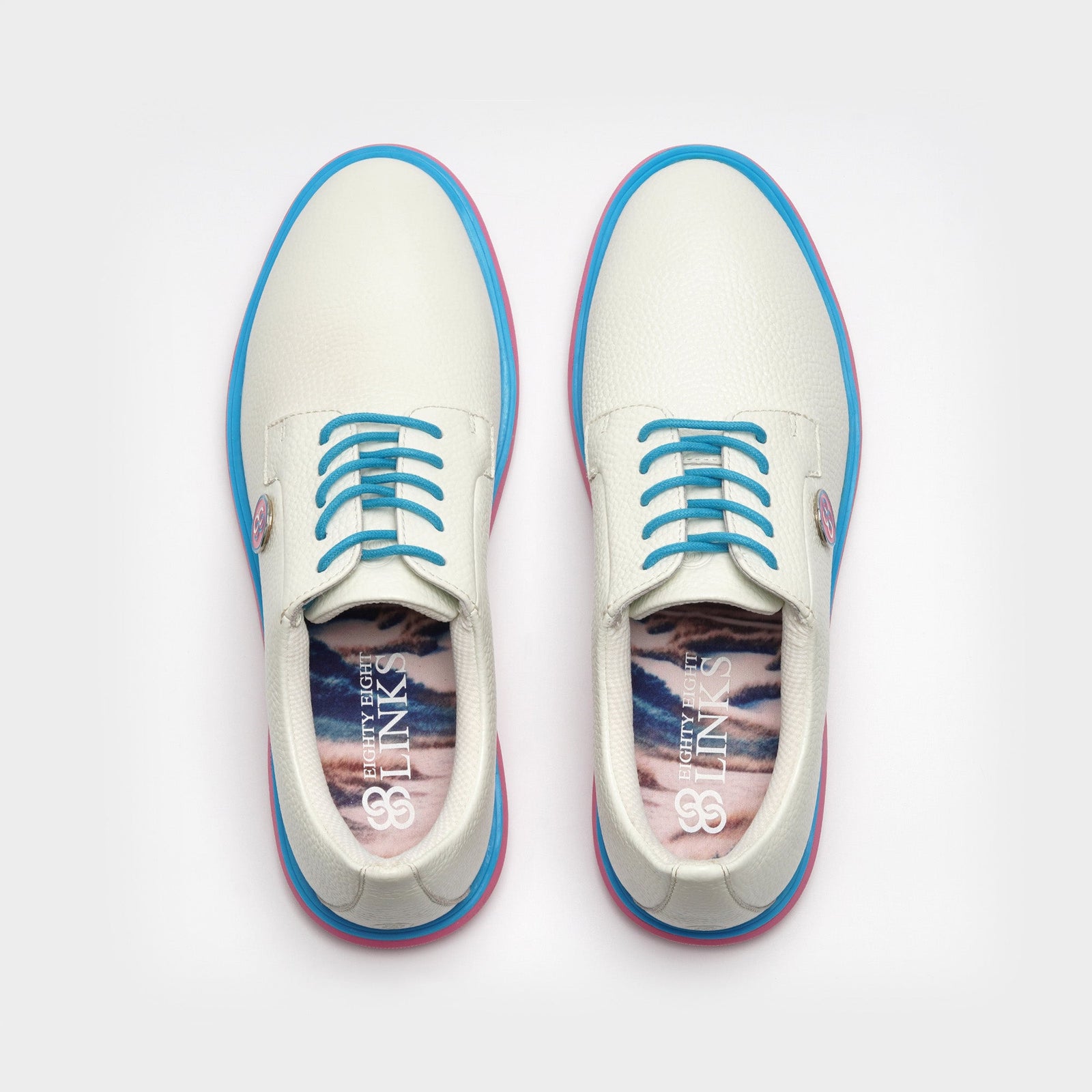 White sneakers with blue accents on a light gray background sells at Paradise Golf