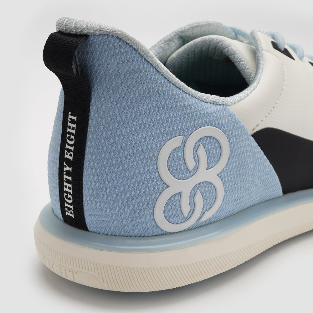 Close-up of a blue sneaker with a brand logo on a light gray background sells at Paradise Golf