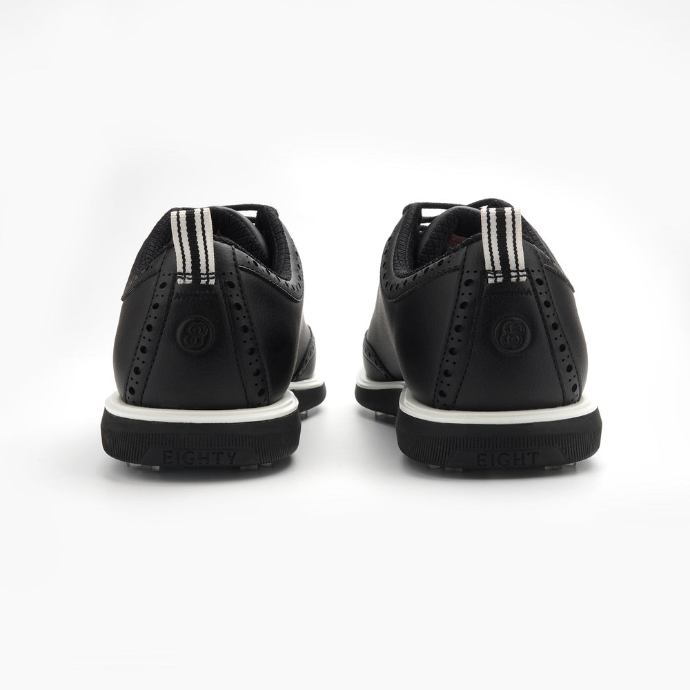Black shoes with white soles on a white background sells at Paradise Golf