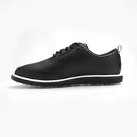 Black leather shoe with white sole on a light gray background sells at Paradise Golf