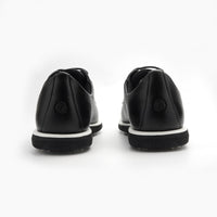 Black leather shoes with white soles on a white background sells at Paradise Golf