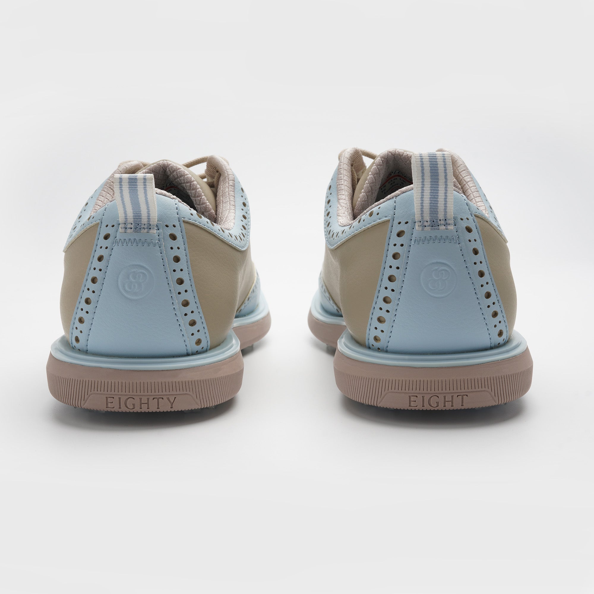 Pair of beige and light blue sneakers on a white background sells at Paradise Golf