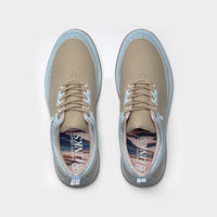 Pair of beige shoes with blue soles on a white background sells at Paradise Golf